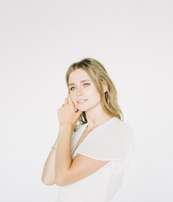 Young woman looking into distance with calm expression in nature